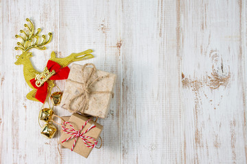 Christmas composition background decoration with metal gold reindeer ornament, gifts on wooden white background. flat lay, top view, copy space