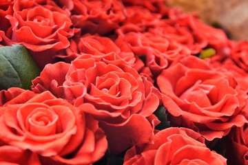 Bouquet beautiful red roses with selective focus in craft paper. Luxury bouquet made of amazing lush lava roses. Valentines Bouquet of red roses. Present for Mother’s Day. Close-up red roses bouquet 