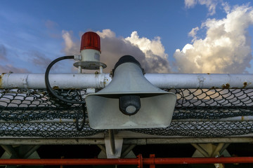 Loudspeaker on board a construction work barge located at netting of a helipad