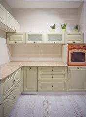 Modern kitchen interior with red walls and white furniture
