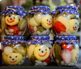 Homemade canned pickles in a jars at christmastime as a gift