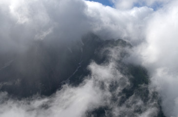 view from a mountain of clouds covering mountains