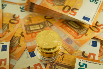 Closeup golden and silver bitcoins are on fifty money Euro Banknoten. P
