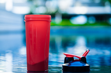 Protein shaker cup with swimming pool background