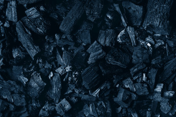 Black charcoal texture abstract surface background. Top view. Color of the year 2020 classic blue toned