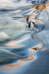 Winter landscape captured with  motion blur of a rapids on the Rabbit River, Michigan, USA