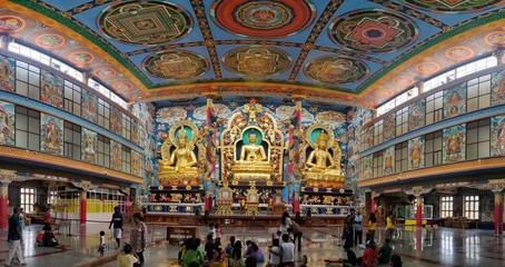 July 8, 2019 - KARNATAKA, INDIA: Panorama of interior of Namdroling Monastery in Coorg district, Karnataka, India. It is also known as Golden Temple and is a Buddhist monastery. Statue of Buddha.