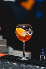 glass of refreshing orange alcoholic cocktail on a table in the bar