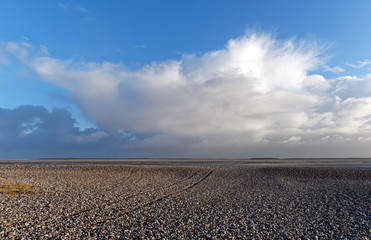 Fototapeta na wymiar cloudy sky on Shingle beach in the bay of somme 