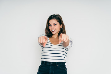 Joyful female pointing fingers at camera