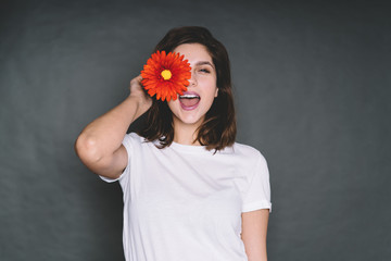 Modern joyful woman with flower