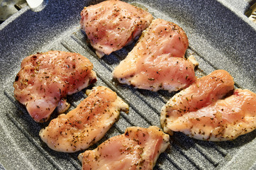 pieces of fried chicken breast. Grilled poultry steak cooked on a grill pan