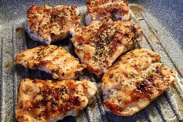 pieces of fried chicken breast. Grilled poultry steak cooked on a grill pan