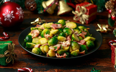 Christmas Brussel Sprouts and Bacon with decoration, gifts, green tree branch on wooden rustic table