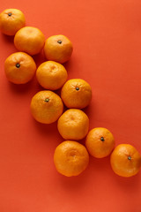 Orange ripe tangerines on an orange background.