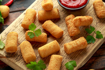 Homemade Potato Croquettes with dipping sauce on wooden board