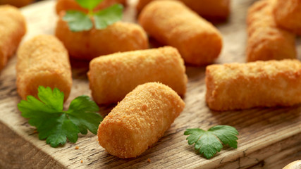 Homemade Potato Croquettes with dipping sauce on wooden board