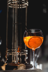 glass of refreshing orange alcoholic cocktail on a table in the bar