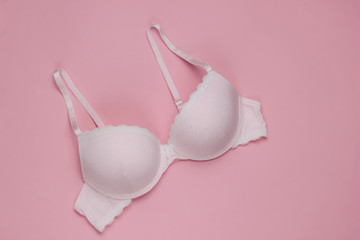 Stylish bra on a pink pastel background. Top view. Beauty and fashion minimalistic still life