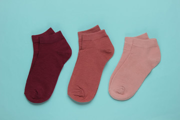 Set of colored socks on blue background. Top view