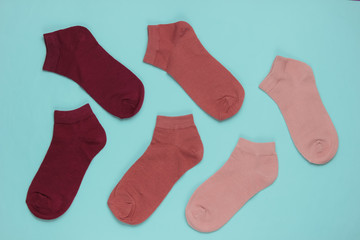 Set of colored socks on blue background. Top view