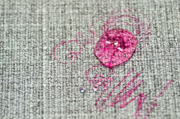Painted fabric on sofa pink marker. Furniture fabric. Cleaning concept
