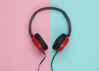 Modern wired headphones on pink blue pastel background. Music lover concept. Top view