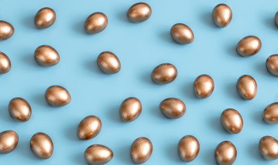 Background with Easter eggs in gold color.