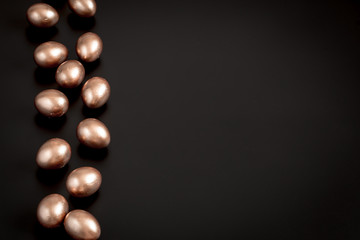 Background with Easter eggs in gold color.