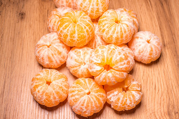 tangerines without peel on the table. background