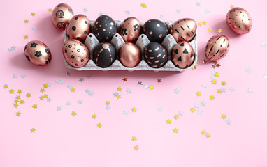 Festive painted Easter eggs on pink background.