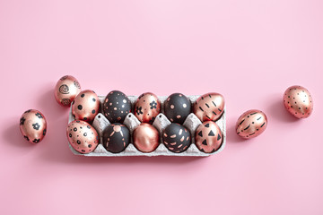 Festive painted Easter eggs on pink background.