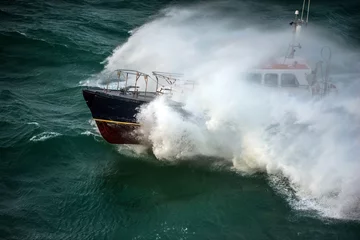 Fototapeten incredible view of a pilot boat in the storm © Image'in