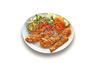 White plate with delicious Chicken filet meat and salad