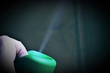 Spraying air refresher from a can in close up