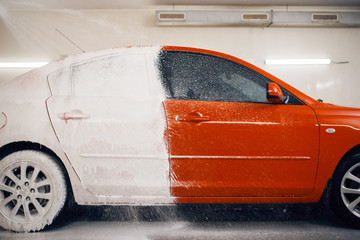 Automobile is half in foam, car wash service