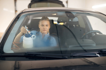 Female washer, view through the windshield