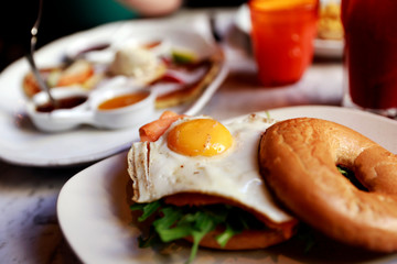 Exclusive breakfast salmon avocado bagel with fried egg. 