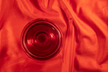 Glass of red wine on bright red cloth