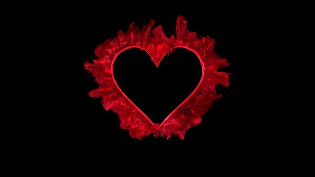 Red color heart shaped Valentine's Day particle love burst. Vivid colored smoke shockwave. Romantic lovely logo and copy space animation. Isolated on black alpha copyspace 4k 60fps