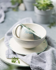 Beautiful ceramic handmade dishes on a light concrete background