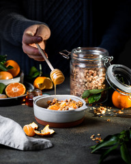 Homemade granola with quinoa, nuts and  clementines