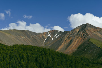 Fototapeta premium cumulus clouds over rock ridge, waiting for rain in mountain valley