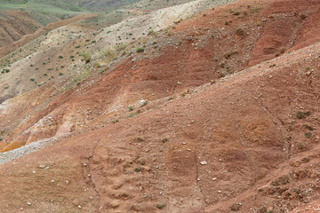 Red hills in canyon. Red colored rocks. Old bed of river in gorge