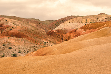 Red canyon in hills. Soil erosion following drought, climate change and formation of gullies. Lack...
