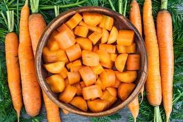 fresh carrots on wooden table after harvesting, cooking for vegetarians, healthy food. Growing vegetables in garden