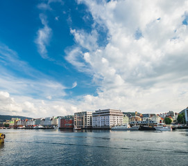 Scenic summer panoramic view of the modern pier architecture, beautiful waters of Byfjorden and cloudy blue sky in Bergen, Norway