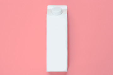 White cardboard box of yogurt on vanilla pink background. Minimalistic eco food concept