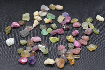 Mixed minerals stone on a black fabric background.