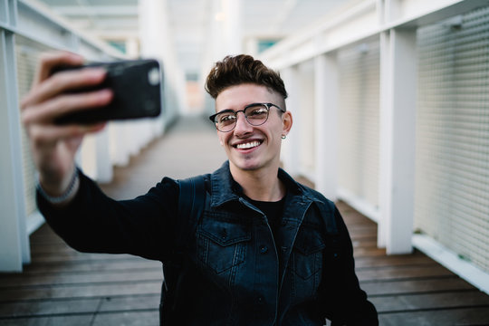 Happy young man taking selfie